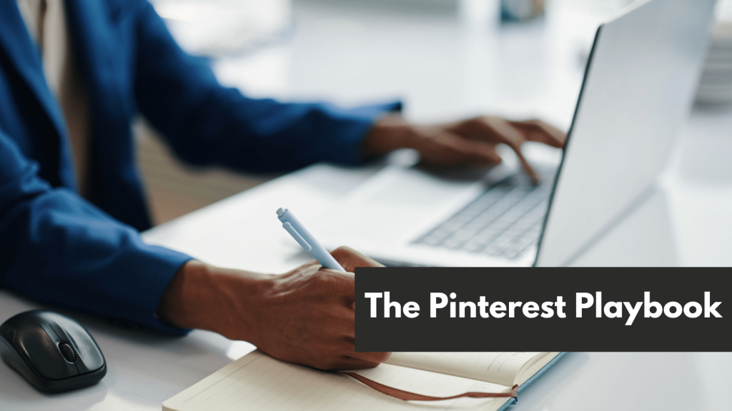 A man holding a pen while typing on his laptop