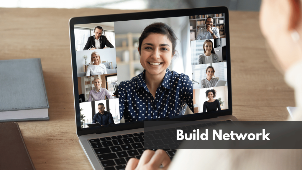 A man looking at a video call with a bunch of other people