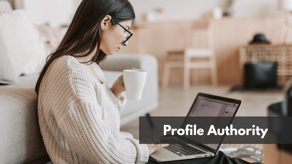Young businesswoman using laptop while taking tea cup at home