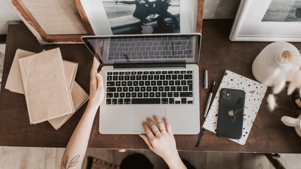 Unrecognizable lady using laptop in workspace