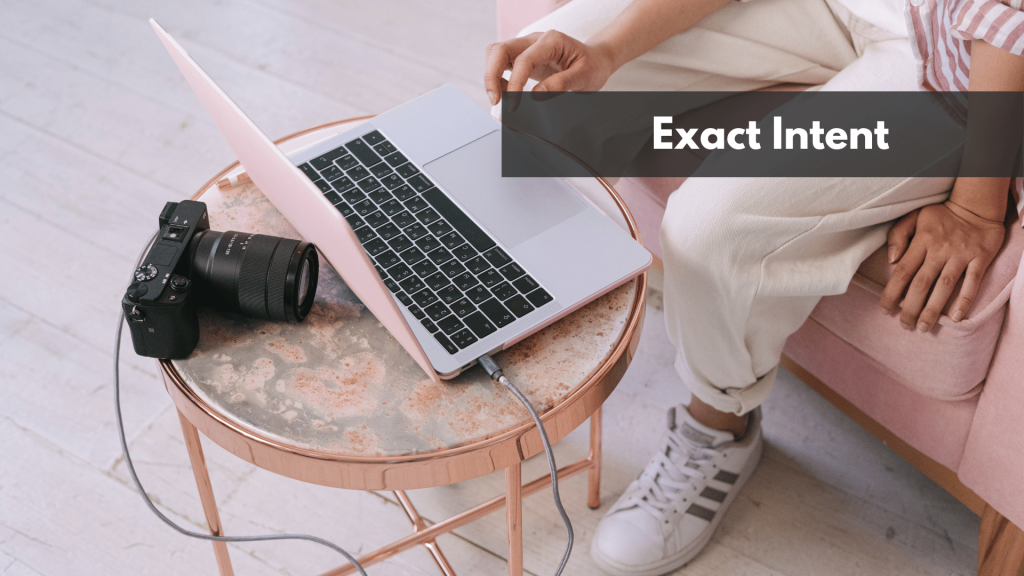 A Person Using a Laptop while sitting on a pink sofa