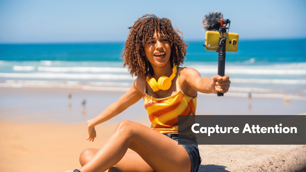 A female blogger in front of the beach while holding her phone 