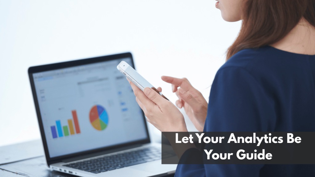 Woman analyzing digital charts on smartphone and laptop, emphasizing the importance of using analytics to guide Pinterest content strategy.