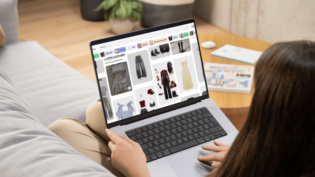 Woman browsing fashion outfit ideas on Pinterest using a laptop for clothing inspiration and trend discovery.