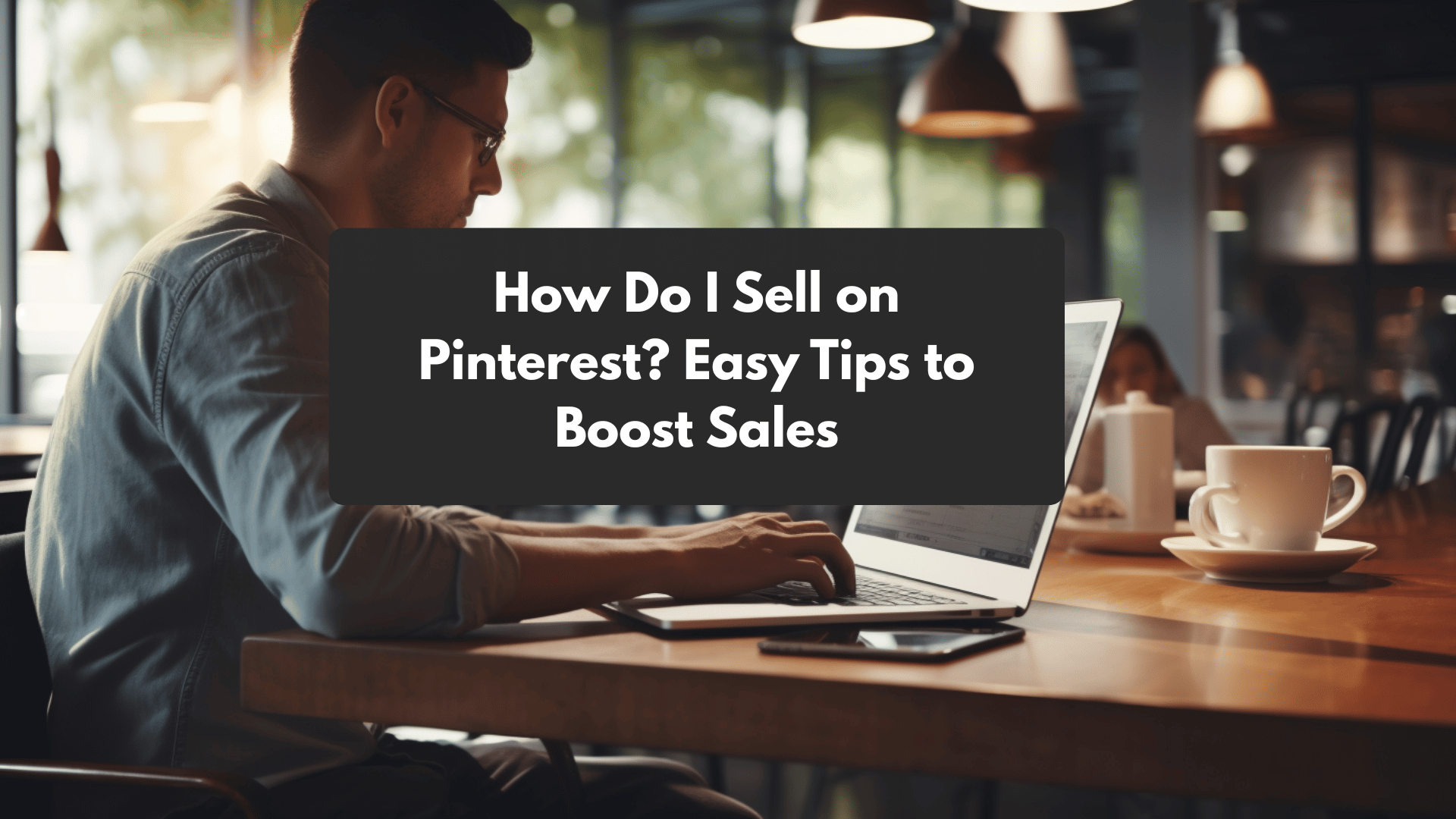Entrepreneur using laptop in a cafe with overlay text 'How Do I Sell on Pinterest? Easy Tips to Boost Sales', representing strategies for ecommerce success on Pinterest.